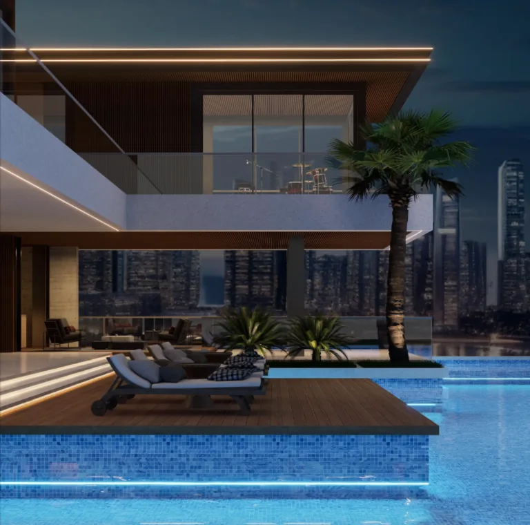 Villa pool and deck against the city skyline at night